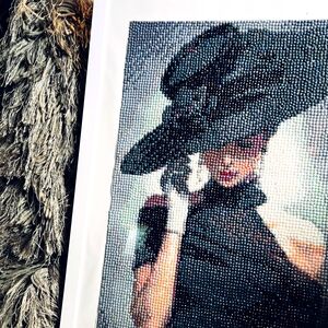 Elegant Beaded Art with Woman in Black Hat